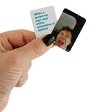A hand with dark nail polish holds two small rectangular cards against a white background. One card is white with blue text reading, 'When a grown-up says your entire generation is spoiled,' and the other is black with a printed photo of a man screaming.