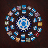 Circular arrangement of trading cards on a dark surface