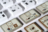 Close-up of various game cards with different symbols on a white background
