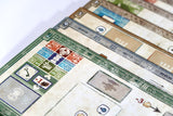 Close-up of board game cards with various symbols and text on a white background