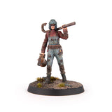 Figurine of a character in a post-apocalyptic setting with a gun on a white background