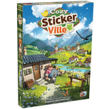 Board game box for 'Cozy Sticker Ville' with a colorful illustration of a village scene.