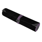 Black yoga mat with purple strap on a white background
