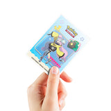 Hand holding a Pokémon trading card with colorful artwork on a white background
