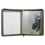 Open notebook with a green cover featuring a design on a white background