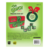 The Grinch Dr. Seuss Premium Dice Set packaging card on a light green background, showing the red gift box, a green ornament, and several dice, with product title, age rating, and small printed details.