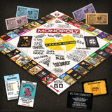 Monopoly game board with colorful property cards and money on a dark surface