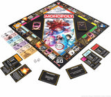 Monopoly: Dracula Slayer board game set displayed on a white background, featuring the illustrated game board, play money, property cards, and action cards.