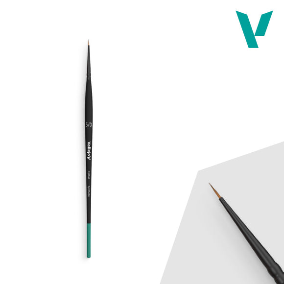 Artistic brush with a green accent on a white background