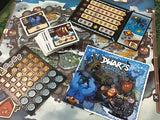 Board game components including cards and a map with 'Dwarfs in Winter' box on a table.