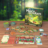 Board game 'March of the Ants' with components on a wooden table against a forest background