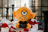 Plush toy cyclops with text, surrounded by red petals on a dark background.
