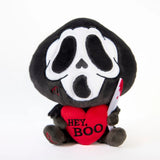 ghost face plush holding a heart with text on it