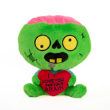 Green plush zombie toy with a pink brain on top, holding a heart that says 'I love you for your brain' on a white background.