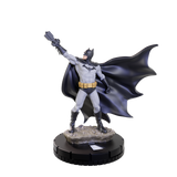 Batman figurine with cape and gloves on a white background