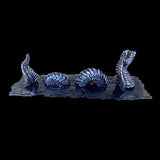 Metallic snake sculpture on a dark background