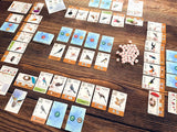 Board game with cards and tokens on a wooden surface
