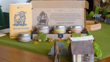 Cantrip Candles packaging with 'Homestead' branding on a decorative table setting.