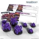 StarCraft tabletop miniatures game set with purple miniatures and game cards on a white background.