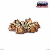 Rock formation toy with 'Masters of the Universe Battleground' logo on a white background