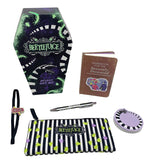Beetlejuice-themed gift set with coffin-shaped box, notebook, pen, pencil case, and wristlet on a white background.