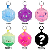 Set of colorful dice-shaped keychains with labels on a white background