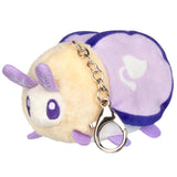 Plush keychain with a purple and beige design on a white background