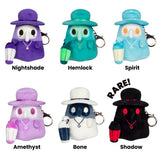 Set of six ghost-themed keychains with labels on a white background