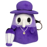 Purple plush keychain with a character wearing a hat and holding a handbag on a white background