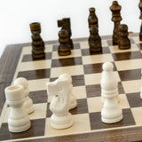 Wooden chess pieces on a checkered chessboard