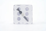 Packaged hair bow with polka dot pattern on a white background