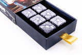 Set of clear game pieces in a black box with a gold ribbon on a white background