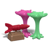 Colorful toy set with a red fish-like figure, pink and green structures on a white background