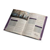 Open book with scenic cover and text on a white background