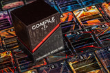 The Compile World board game box, programmed by Michael Yang, displayed on top of a game board filled with colorful cards.