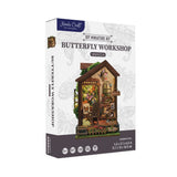 Hands Craft DIY Miniature Kit: Butterfly Workshop box packaging, featuring a detailed illustration of the miniature workshop on a white background with subtle floral patterns.