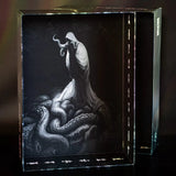 Decorative box with a black and white illustration of a hooded figure and tentacles on a dark background.
