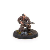 Miniature figure of a soldier holding a rifle on a round base with a white background