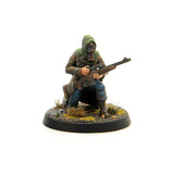 Miniature figure of a soldier in a gas mask with a rifle on a white background