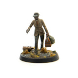 Figurine of a man in a suit with a hat and suitcase on a white background