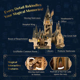 A promotional graphic for a Hogwarts castle model set on a dark blue background. The image shows the assembled castle with labeled callouts including Moving Staircases, Hospital Wing, Headmaster's Office, The Great Hall, Room of Requirement, Library, and Prefects' Bathroom.