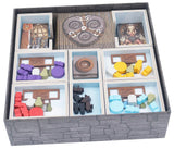 Board game components in a storage box with various pieces and tiles.