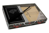 Stationery set with a black notebook, pen, and letter in a decorative box.