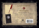 Front cover of the House Targaryen Desktop Stationery Set by HBO's Game of Thrones, featuring a parchment-style layout with a red quill, letterhead paper, envelope, and a black Targaryen sigil card on a dark patterned background.