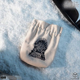 White drawstring bag with Iron Throne design on a snowy background, featuring Game of Thrones branding.