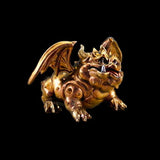 Bronze gargoyle figurine on a black background