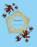 Decorative book page with frogs and a gold emblem on a blue background