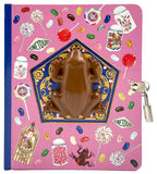 Notebook with a chocolate frog design on a pink cover featuring candy illustrations.