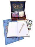 Open notebook with pen, stationery set, and decorative box on a white background