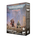 Warhammer 40,000 Astra Militarum Ciaphas Cain miniatures packaging with two figures on a desert landscape.